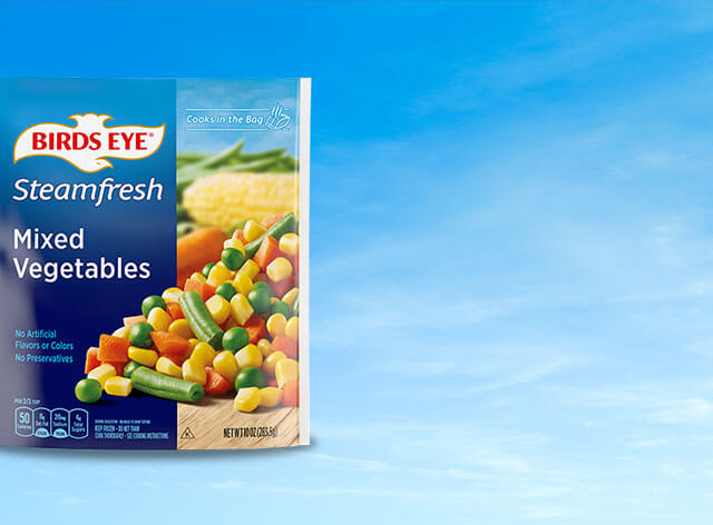 Birds Eye Steamfresh Mixed Vegetables package on a sky with clouds background